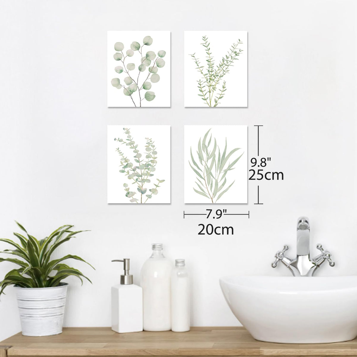 Four sage botanical canvas prints above a bathroom sink