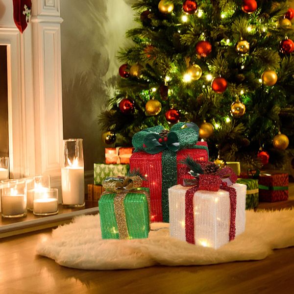 Lighted Christmas gift boxes under a Christmas tree on a white rug