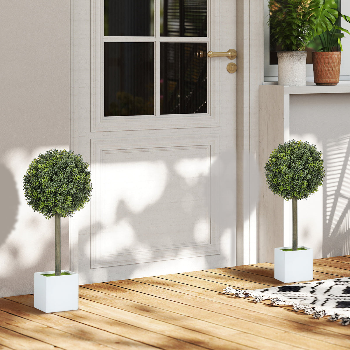 Topiary pair by a doorway