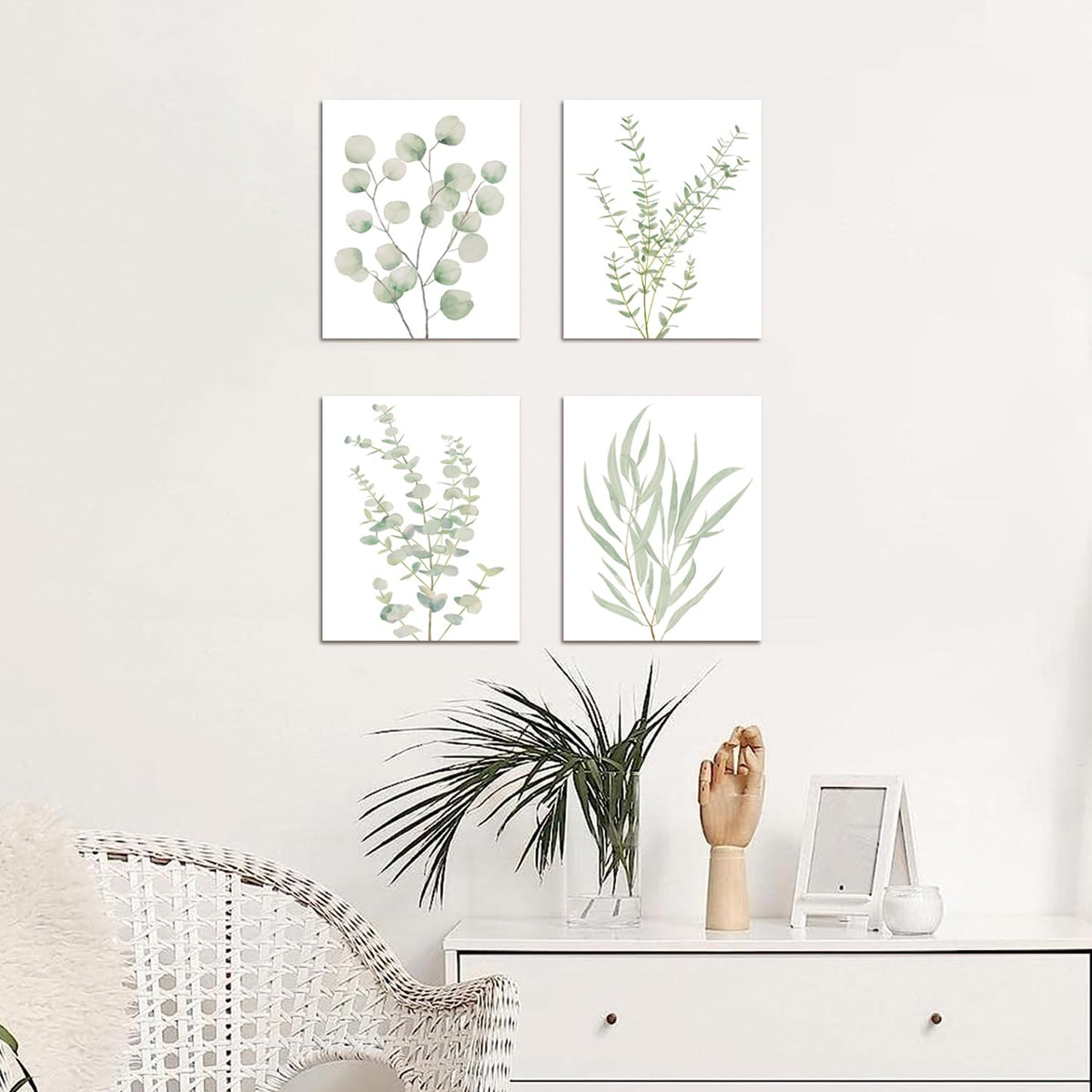 Sage leaf canvas prints above a white dresser