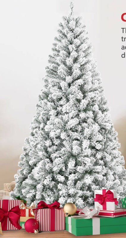 Snow flocked Christmas tree in a cozy living room